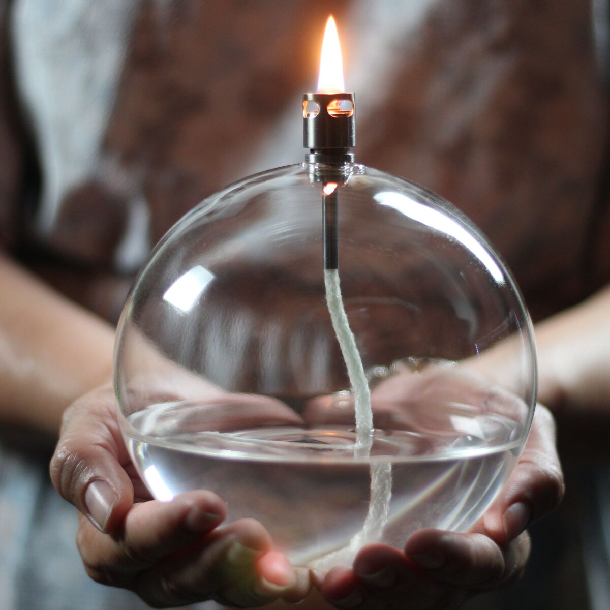 The flame seems to float magically on the glass.