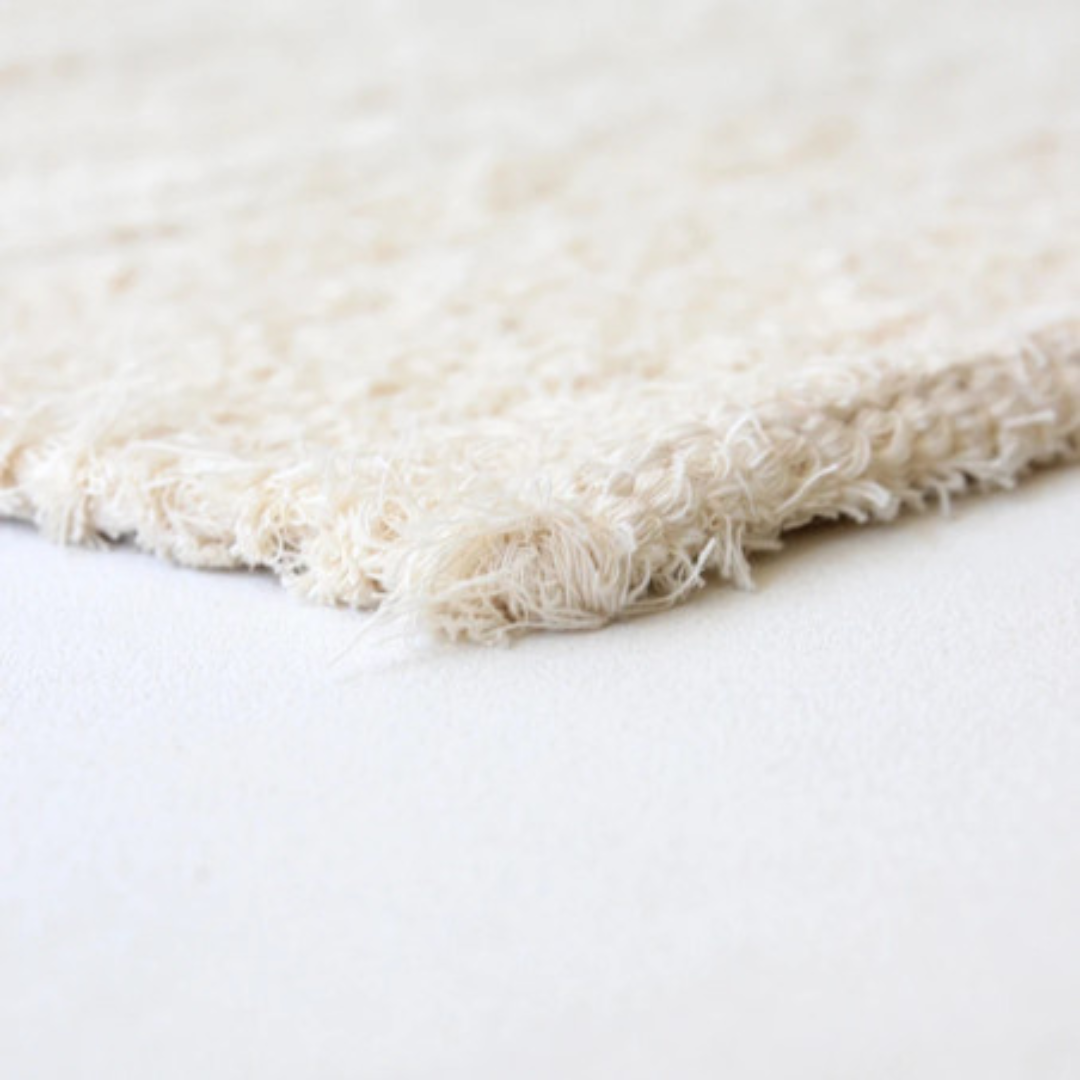Détail texture tapis Gaou coton recyclé Masamé, finitions artisanales couleurs douces