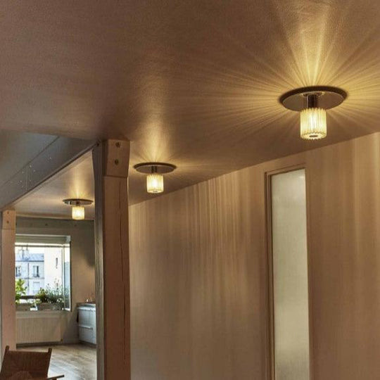 Jeux d'ombres et lumière créés par l'applique In the Sun sur mur blanc