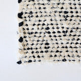 Détail finitions tapis Piana coton écologique design épuré Masamé